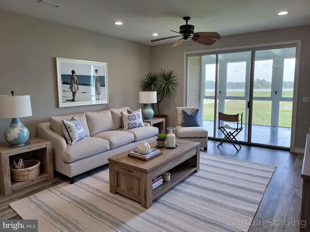 a living room with furniture and a floor to ceiling window