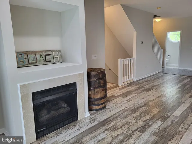 an aerial view of a house with a garden and lake view