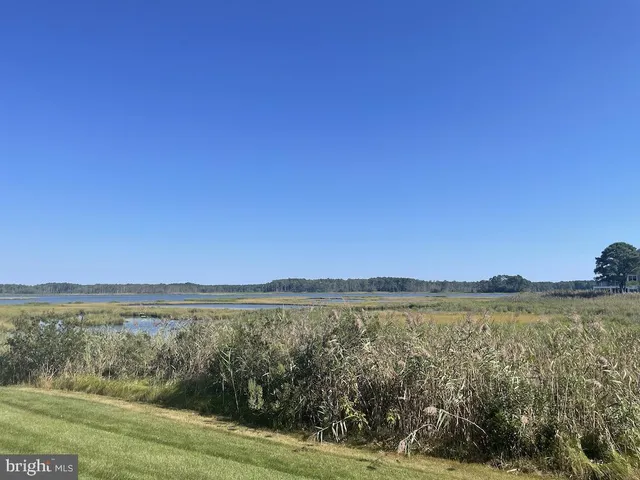 an aerial view of a house with a swimming pool and outdoor seating