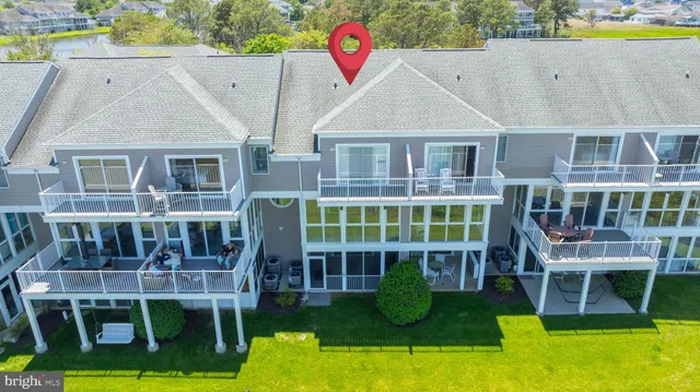 an aerial view of a house with swimming pool and porch