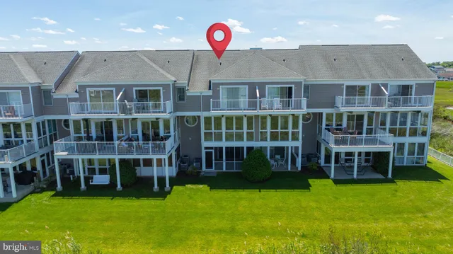 an aerial view of a house with outdoor seating