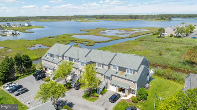 an aerial view of lake and residential houses with outdoor space