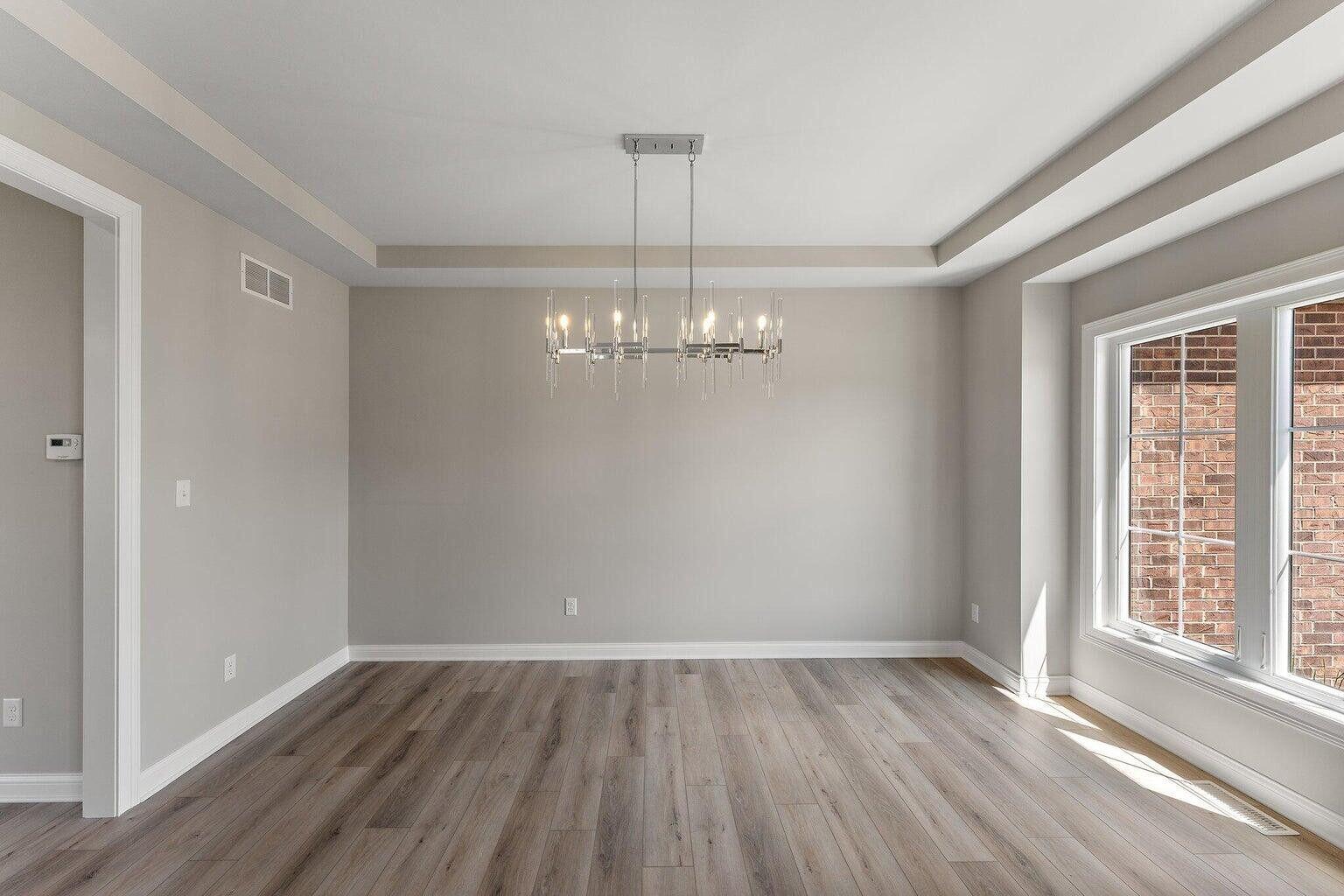 3090 West 105th Avenue Crown Point, IN 46307 - Photo 3 of 22 a view of a room with wooden floor chandelier and window