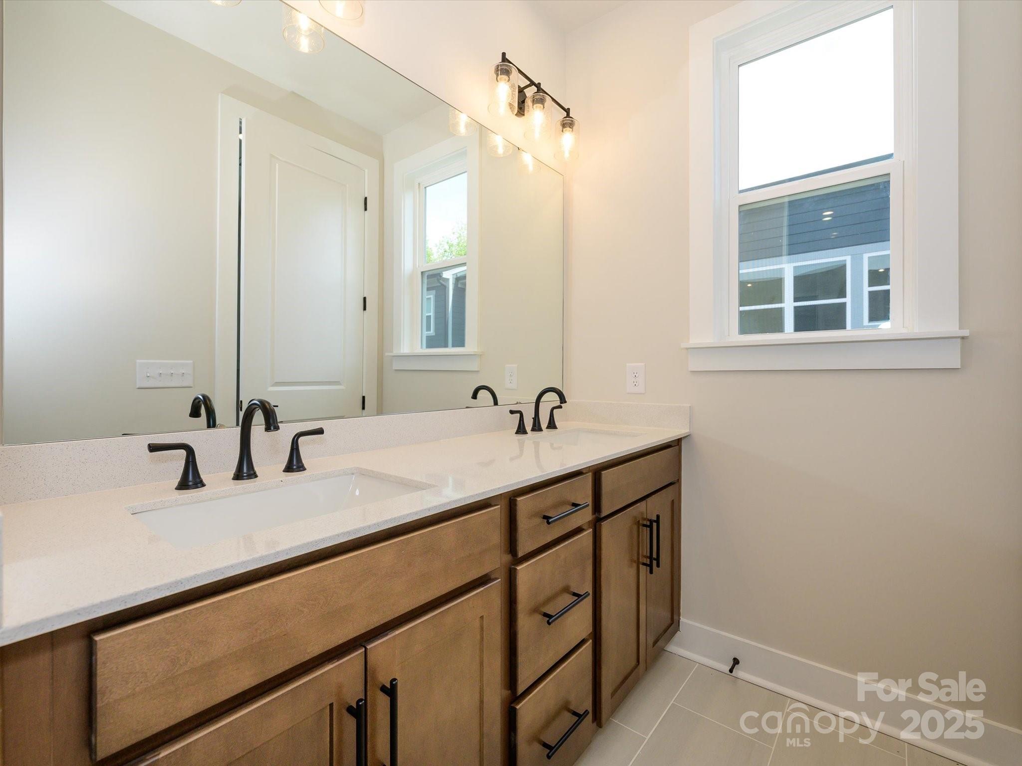 6009 Pivot Court Charlotte, NC 28205 - Photo 11 of 16 a bathroom with a sink and a mirror