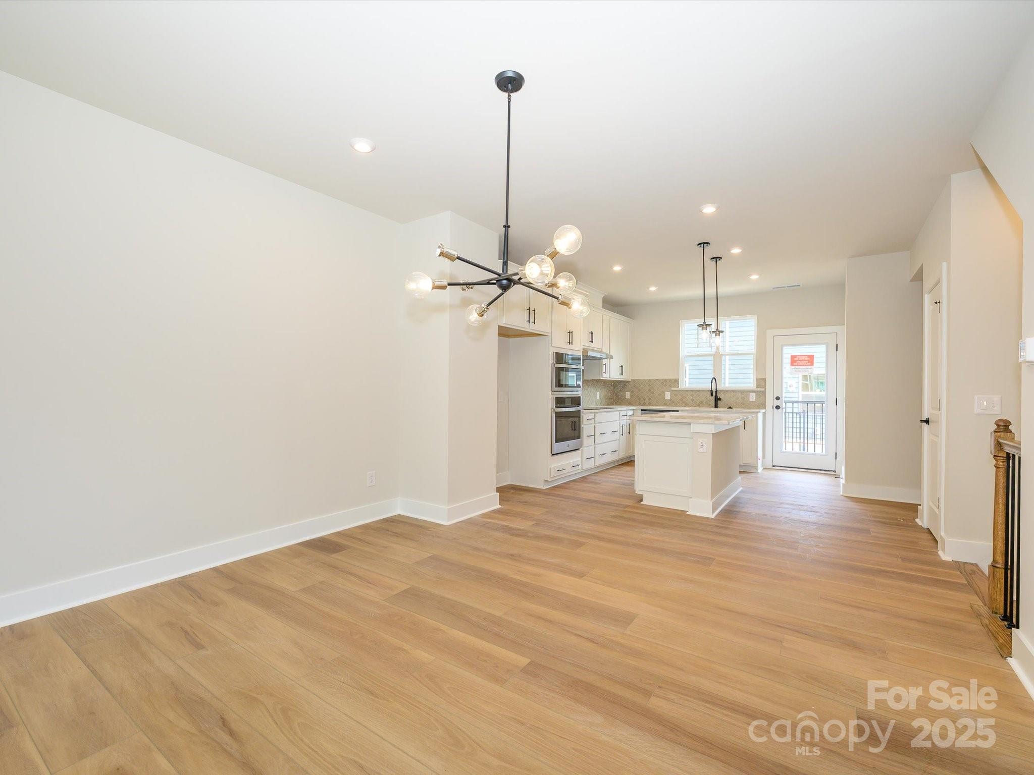 6009 Pivot Court Charlotte, NC 28205 - Photo 6 of 16 a view of a kitchen with a sink stainless steel appliances and cabinets