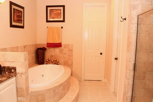 a bathroom with a tub and shower