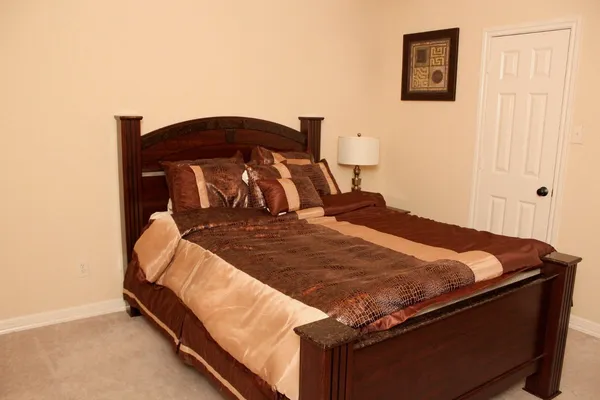 a bed sitting in a bedroom next to a window