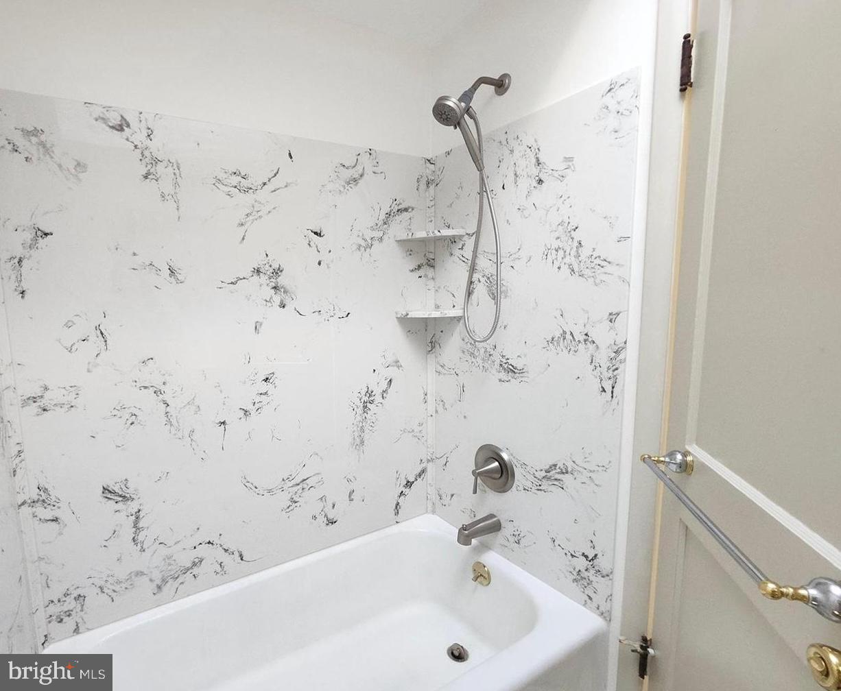 22 Wayne Avenue Trooper, PA 19403 - Photo 11 of 13 a bathroom with a bathtub and shower