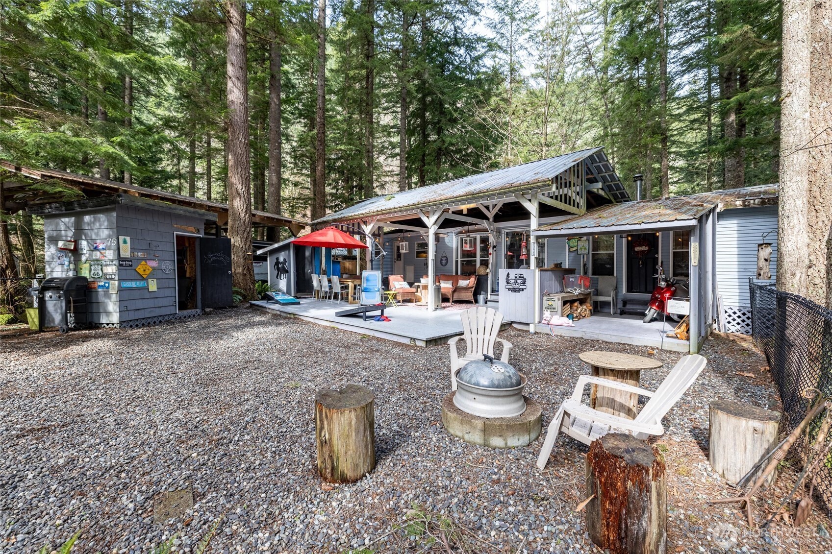 1075 Birch Lane Maple Falls, WA 98266 - Photo 16 of 16 a view of a patio with table and chairs potted plants and large tree