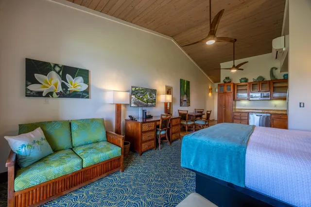 a bedroom with a bed a table and chair