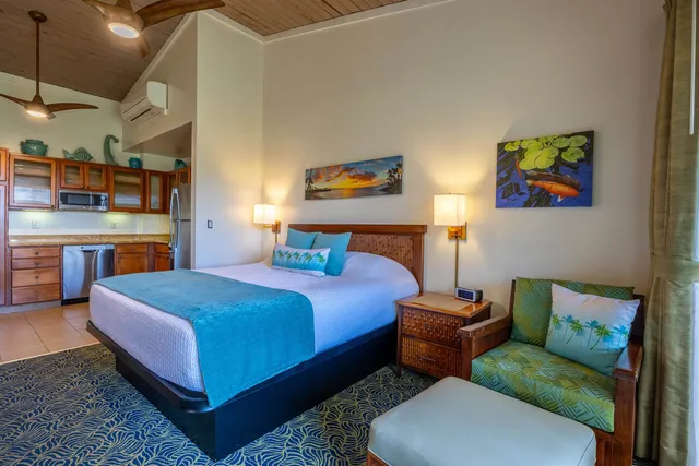 a bedroom with a bed a couch and a night stand