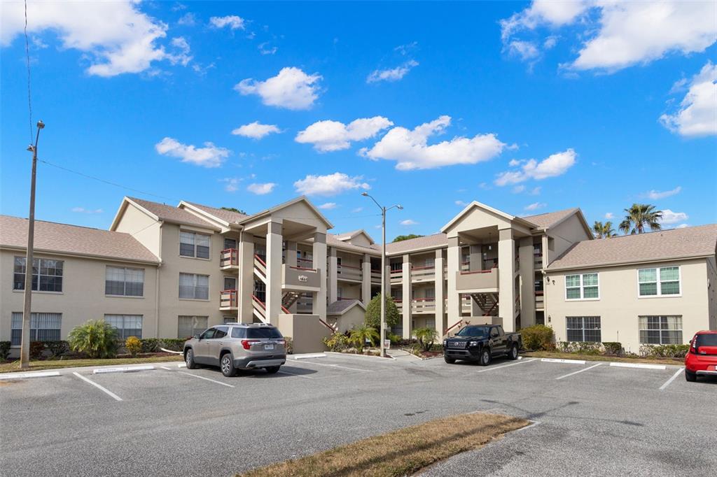 4529 Whitton Way, Unit 211 New Port Richey, FL 34653 - Photo 1 of 1 a view of a parked cars in front of a building