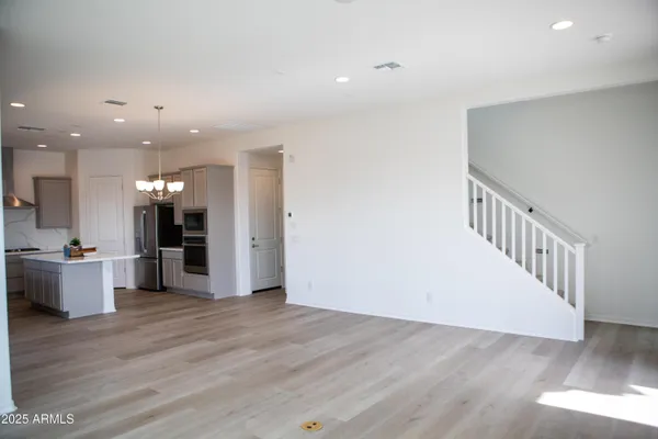 a view of a kitchen with furniture and wooden floor