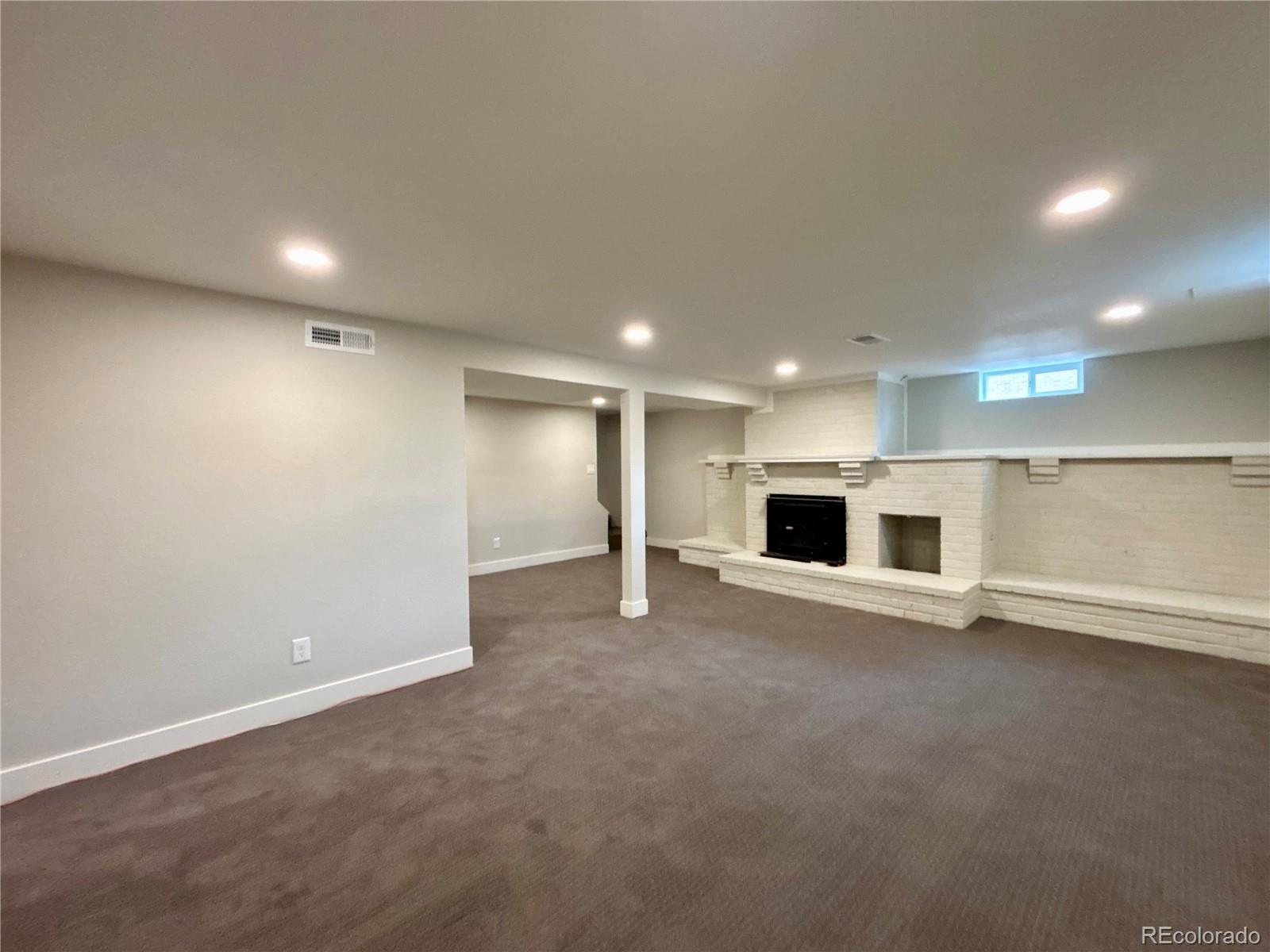 4420 Teller Street Wheat Ridge, CO 80033 - Photo 12 of 20 an empty room with a kitchen and a microwave