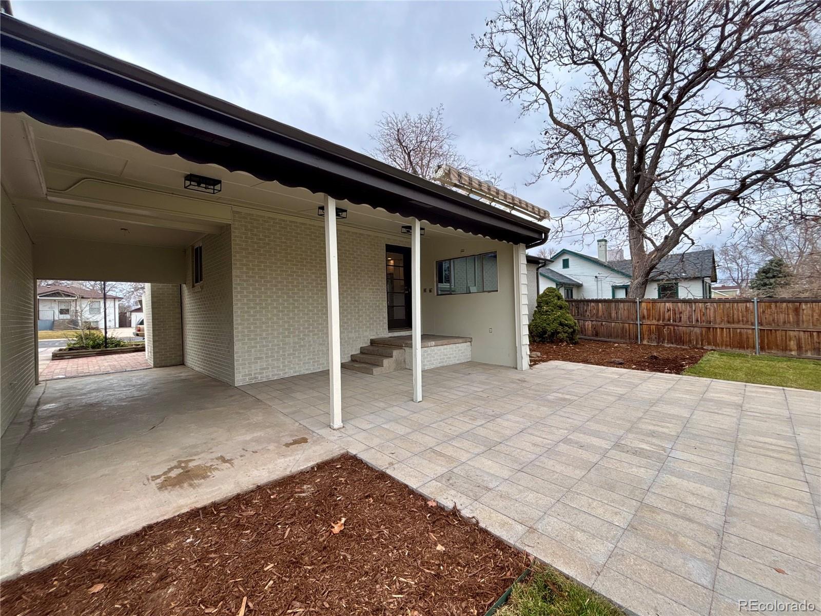 4420 Teller Street Wheat Ridge, CO 80033 - Photo 17 of 20 a view of a house with a yard