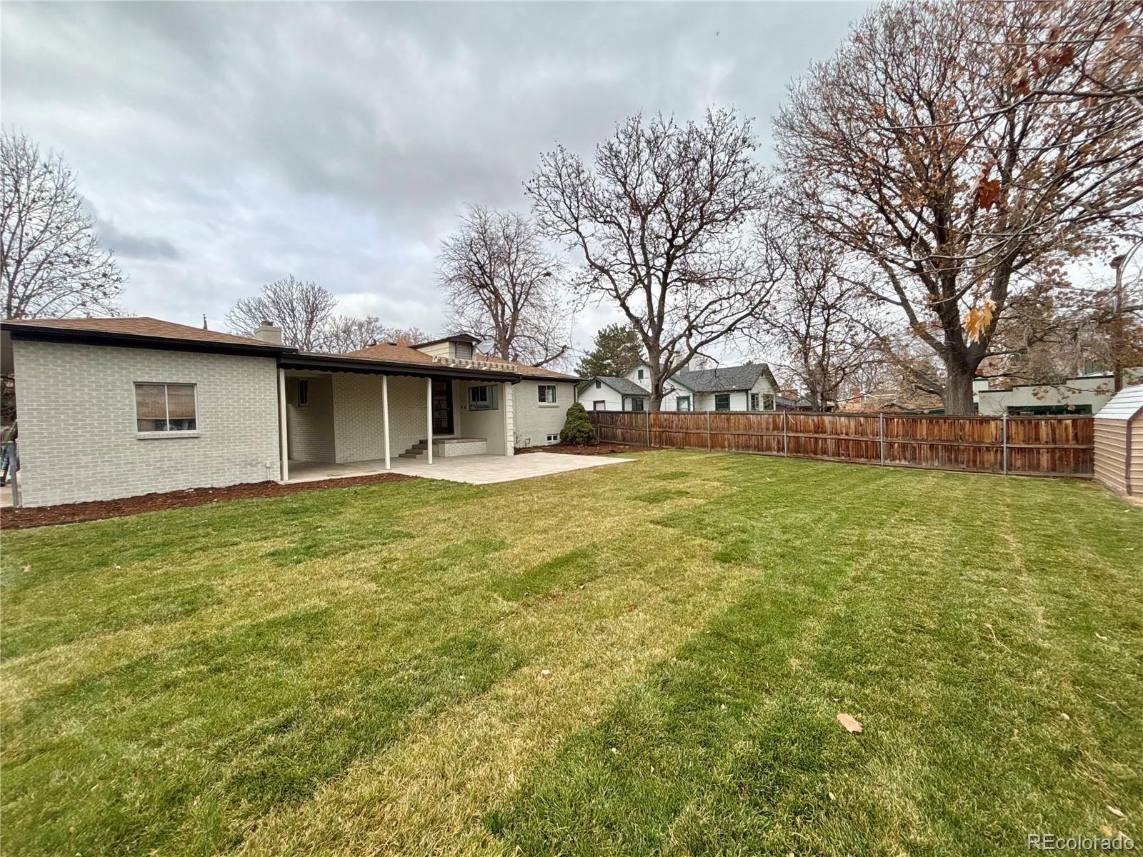 4420 Teller Street Wheat Ridge, CO 80033 - Photo 19 of 20 a front view of house with yard and trees