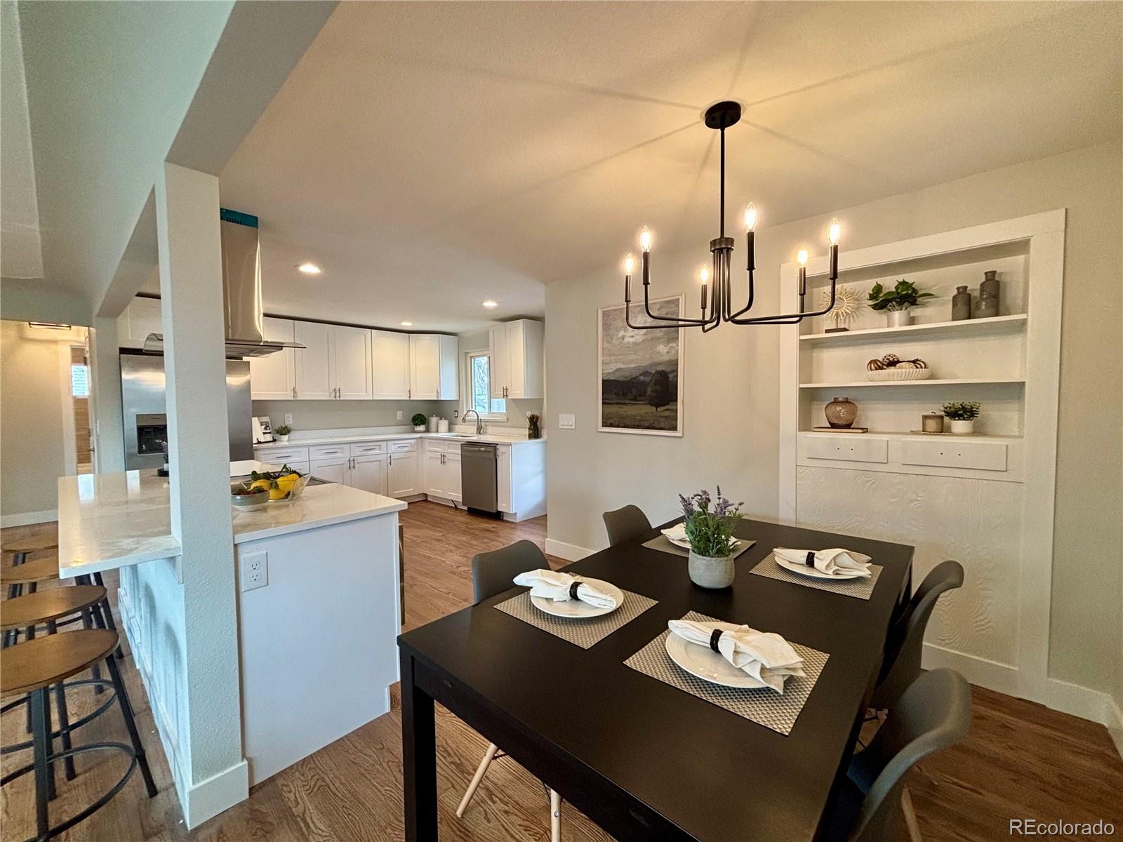4420 Teller Street Wheat Ridge, CO 80033 - Photo 4 of 20 a kitchen with a refrigerator coffee maker on table and chairs