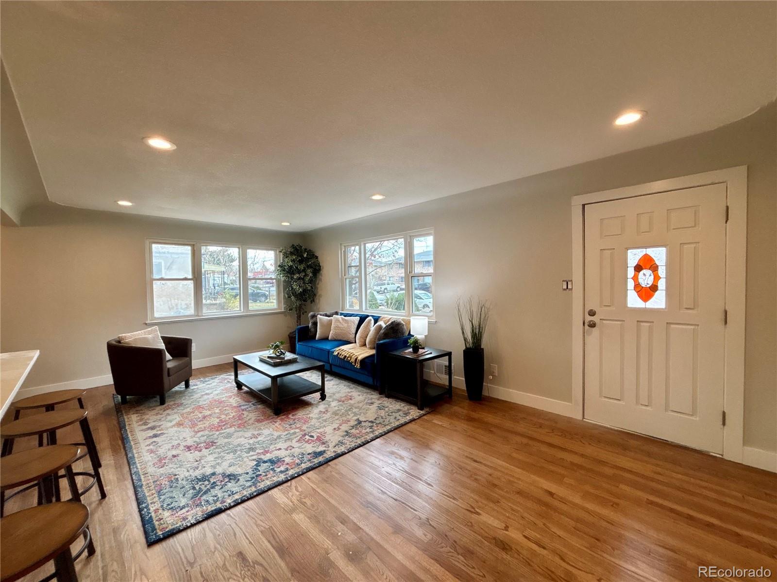 4420 Teller Street Wheat Ridge, CO 80033 - Photo 8 of 20 a living room with furniture window and wooden floor