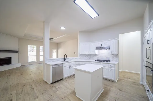a kitchen with a sink stove and refrigerator