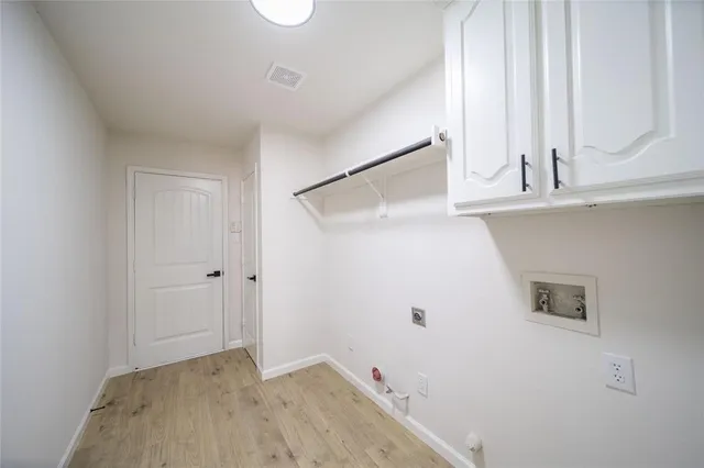 a view of a closet area with wooden floor