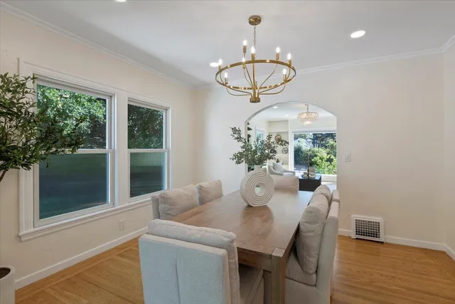 a view of a dining room with furniture wooden floor and chandelier