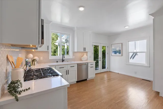 a kitchen with sink a stove and cabinets
