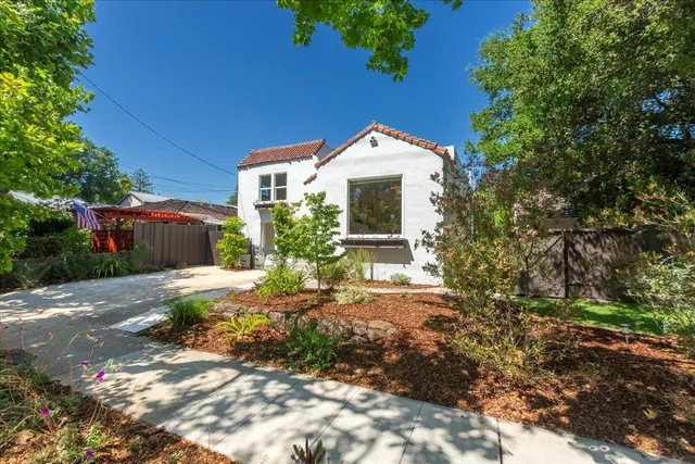 a front view of a house with garden