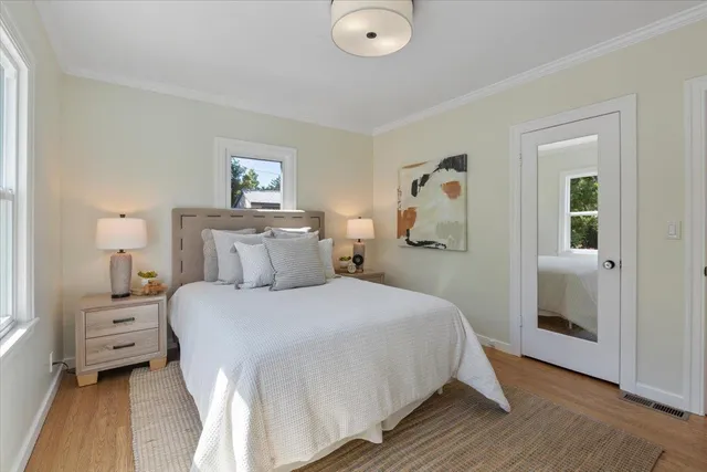 a bedroom with a bed and wooden floor