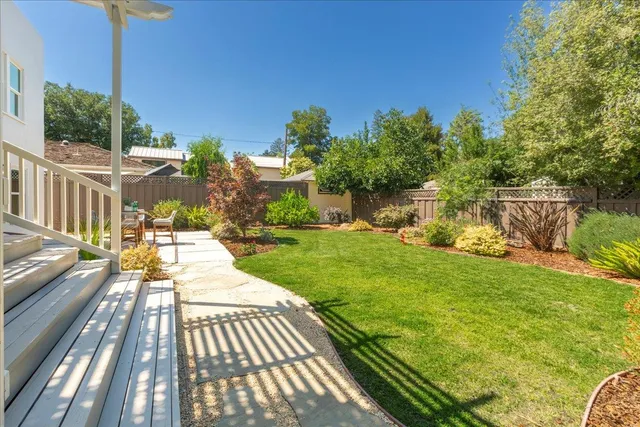 a view of a backyard with plants and a patio