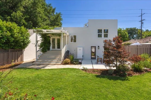 a view of a house with a yard and a garden