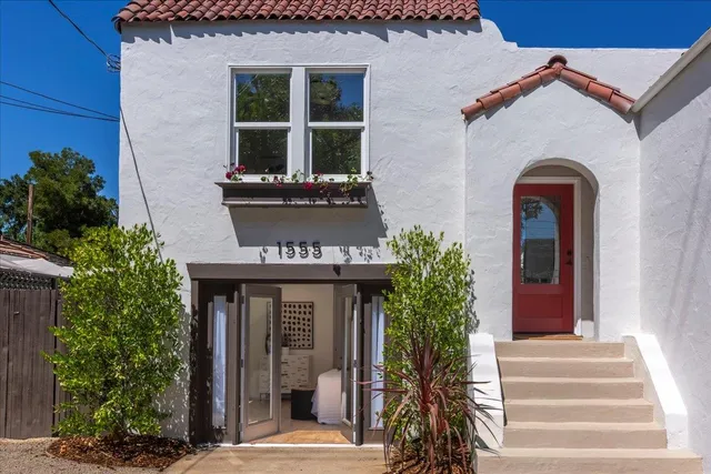 a front view of a house with plants