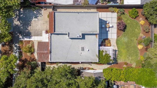an aerial view of a house with a yard basket ball court and outdoor seating