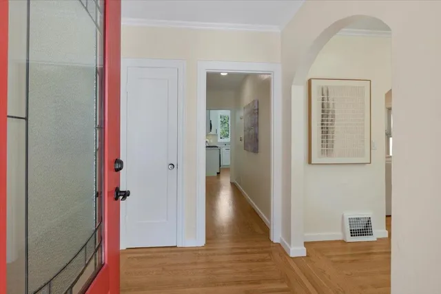 a view of a hallway with wooden floor