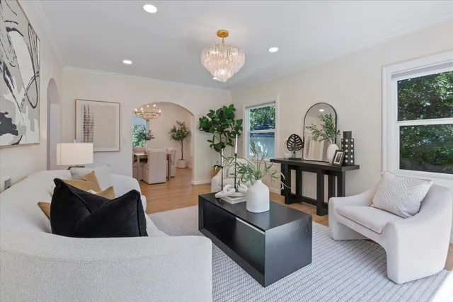 a living room with furniture and a chandelier