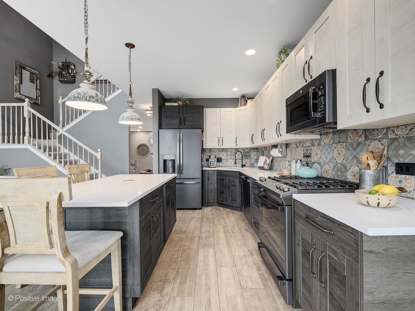 1016 Hummingbird Way Bartlett, IL 60103 - Photo 14 of 41 a kitchen with stainless steel appliances granite countertop a sink a stove and a wooden floors