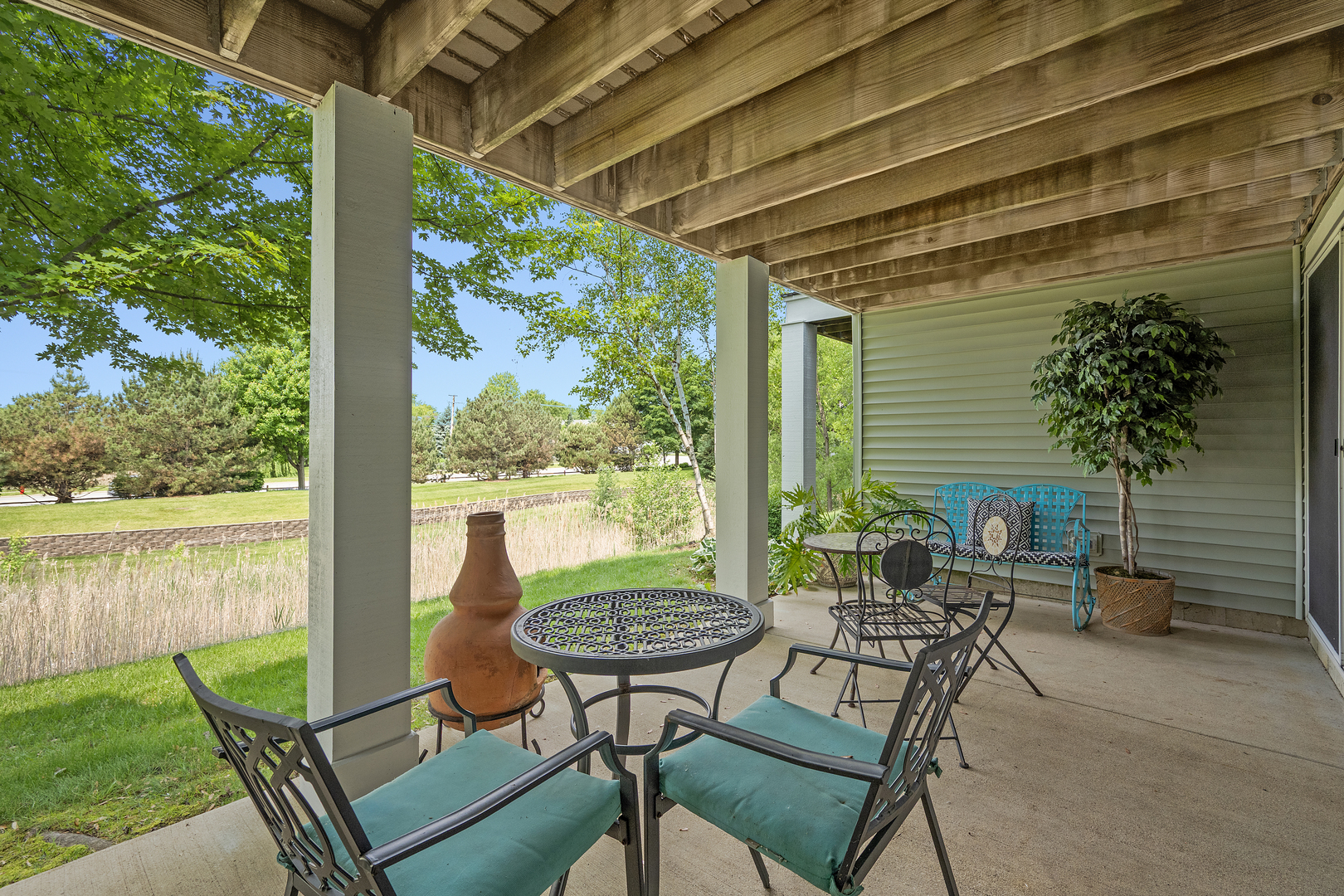1016 Hummingbird Way Bartlett, IL 60103 - Photo 35 of 41 a view of a patio with table and chairs potted plants with wooden floor and floor to ceiling window