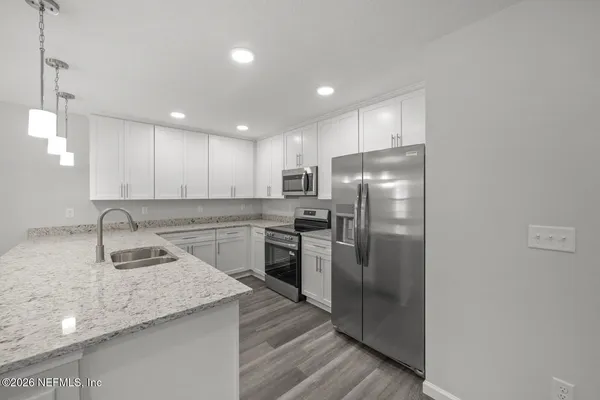 a kitchen with a sink stove and cabinets