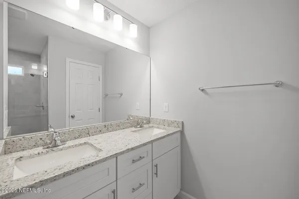 a bathroom with a glass shower door