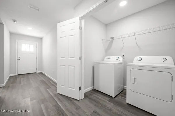 a view of an house with backyard and a patio