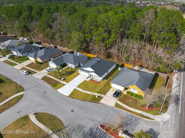 an aerial view of residential houses with yard
