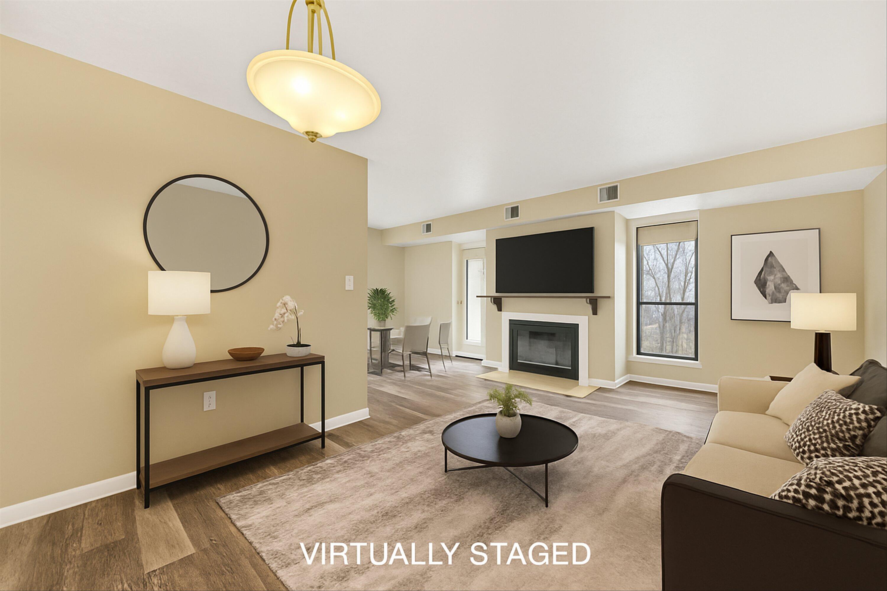 a living room with furniture a fireplace and a flat screen tv