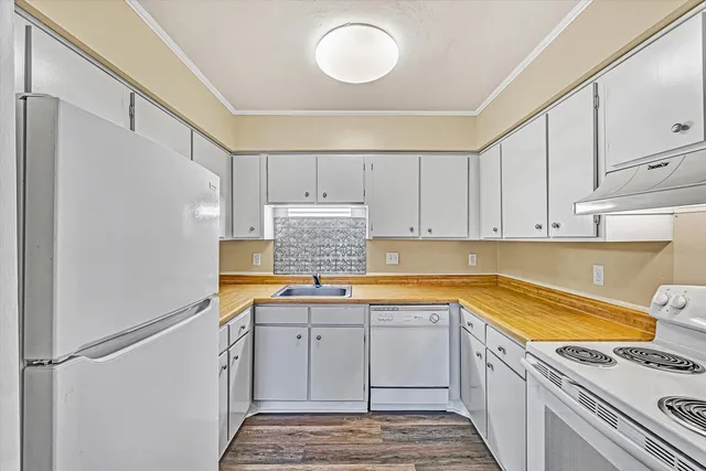 a kitchen with granite countertop a sink stainless steel appliances and cabinets