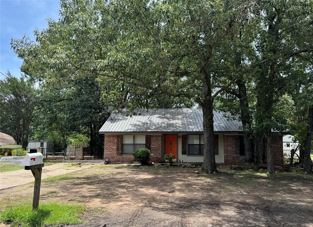 4515 Southeast Loop 286 Paris, TX 75460 - Photo 12 of 37 a view of a house with backyard and a tree