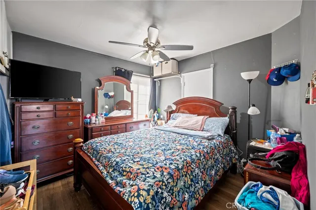 a bedroom with a bed and flat screen tv