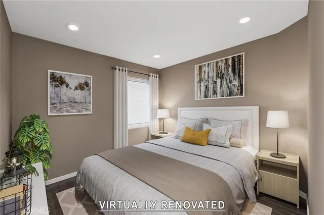 a bedroom with a bed and a painting on the wall