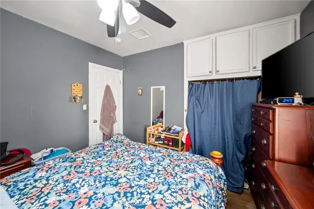 a bedroom with bed and wooden floor