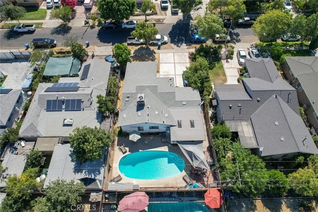an aerial view of residential houses with city view