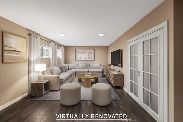 a living room with furniture a large window and a flat screen tv