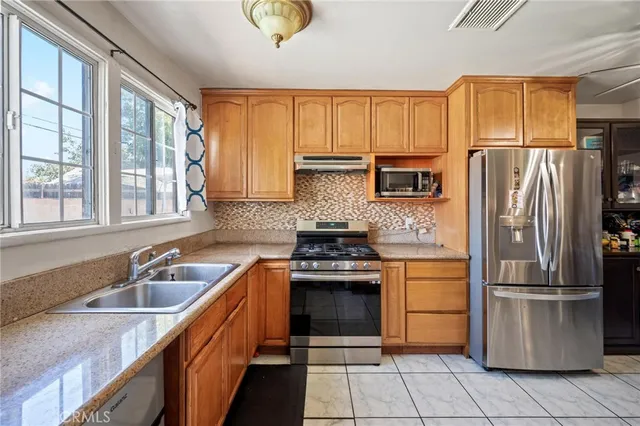 a kitchen with a sink stove and refrigerator