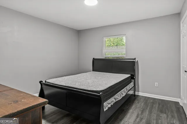 a bed sitting in a bedroom next to a window